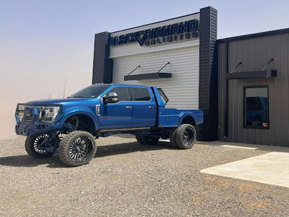 Black Diamond Unlimited shop in Ropesville, TX with a lifted blue Ford Super Duty